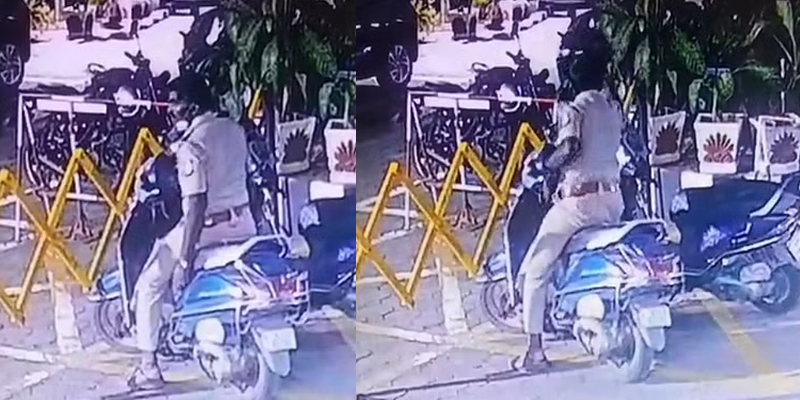 போலீசே இப்படி செய்யலாமா??…பைக்கில் இருந்த ஹெல்மெட்டை திருடும் காவலர்..!!